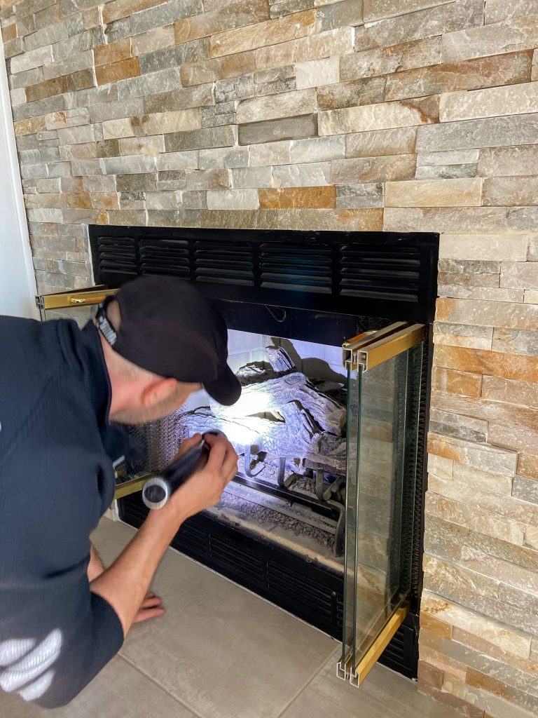 Home Inspector inspecting a fireplace